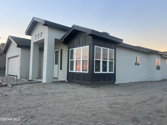 property exterior at dusk with a garage