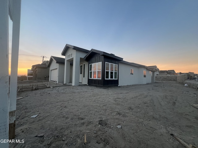 property exterior at dusk with a garage