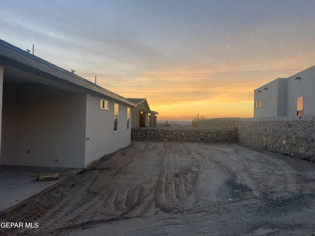 view of side of home with stucco siding