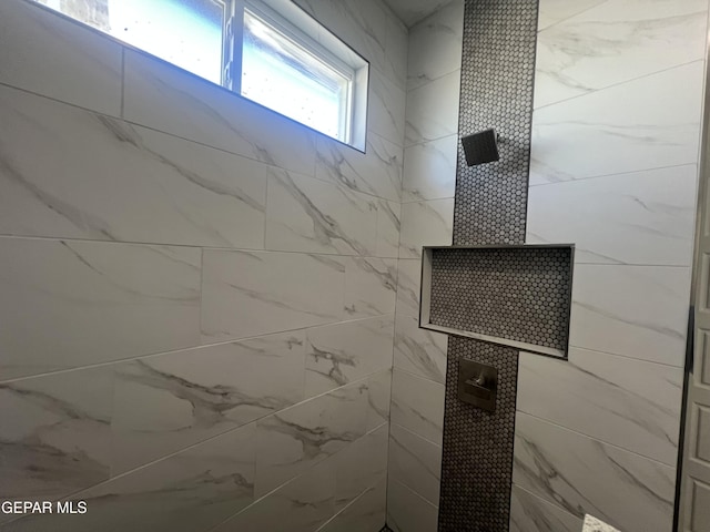 full bath featuring a tile shower