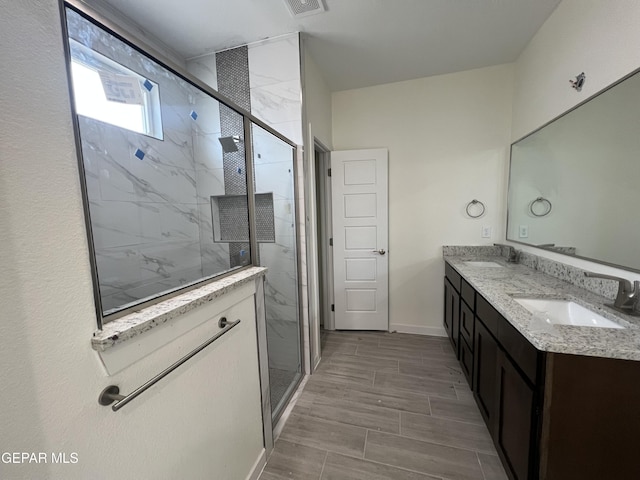 full bathroom featuring a shower stall, baseboards, and a sink