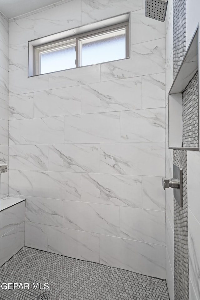 bathroom featuring tiled shower