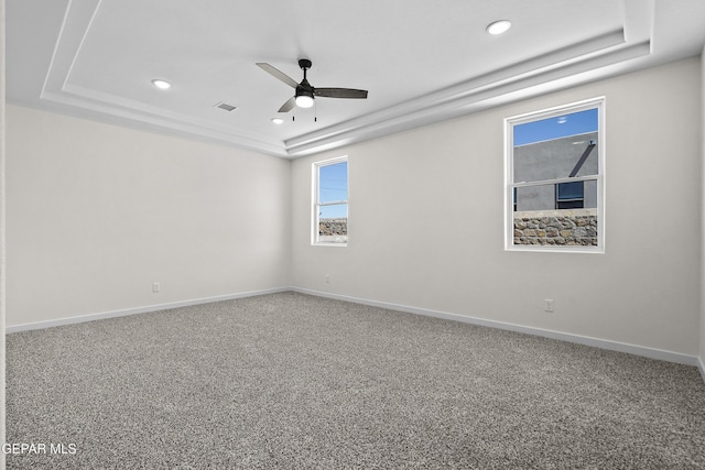 empty room with recessed lighting, baseboards, visible vents, a raised ceiling, and a ceiling fan
