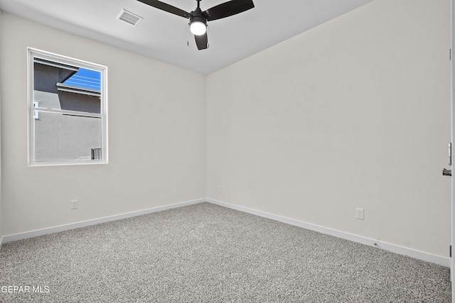 carpeted spare room featuring visible vents, ceiling fan, and baseboards