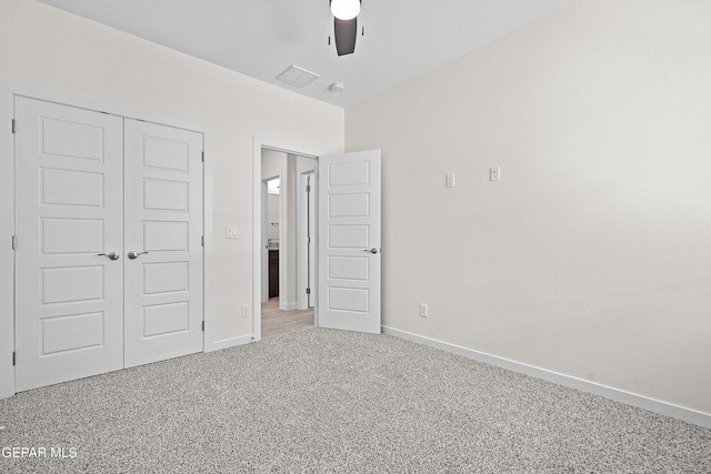 unfurnished bedroom with carpet, ceiling fan, a closet, and baseboards