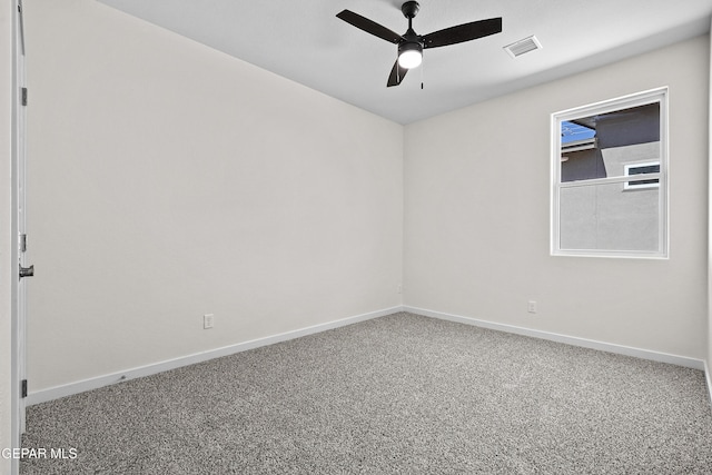 unfurnished room featuring baseboards, visible vents, a ceiling fan, and carpet flooring