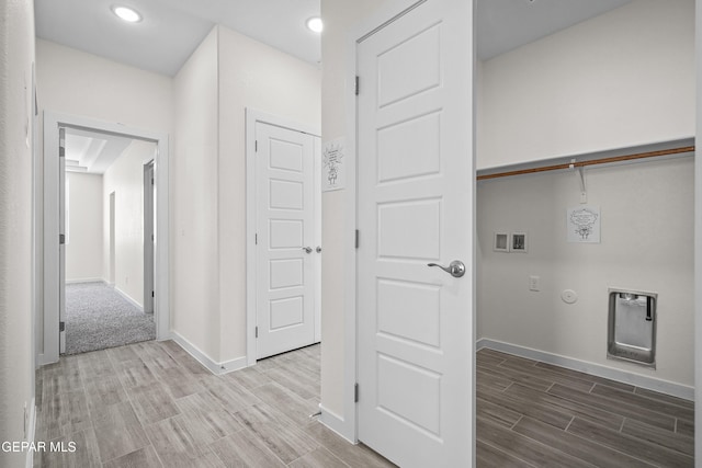 corridor with wood tiled floor, recessed lighting, and baseboards