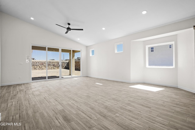 unfurnished living room featuring ceiling fan, a healthy amount of sunlight, wood finished floors, and baseboards