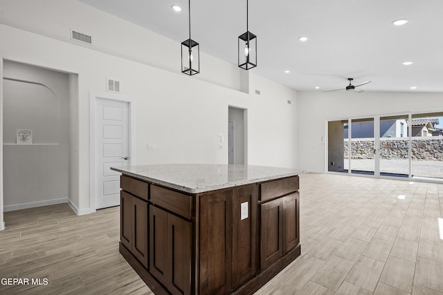 kitchen featuring pendant lighting, visible vents, ceiling fan, and light wood-style flooring