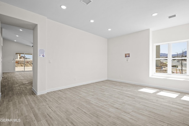 spare room with a healthy amount of sunlight, recessed lighting, and visible vents