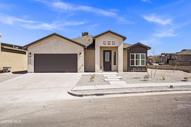 view of front of property with a garage, a shingled roof, stucco siding, and driveway