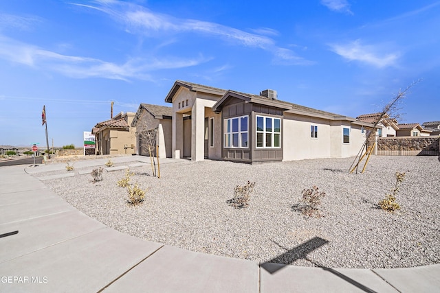 view of side of home featuring board and batten siding and stucco siding