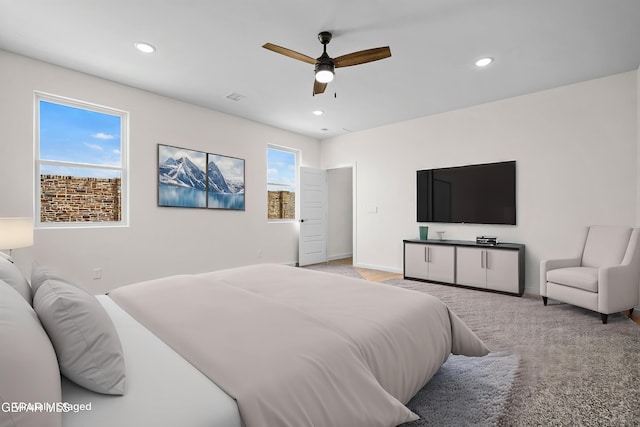 bedroom with light colored carpet, recessed lighting, baseboards, and a ceiling fan