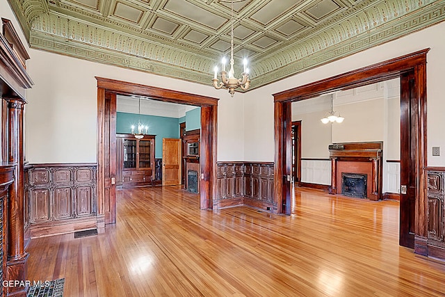 unfurnished room featuring hardwood / wood-style flooring and a chandelier