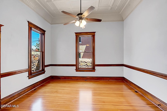 spare room with ceiling fan, ornamental molding, and light hardwood / wood-style floors