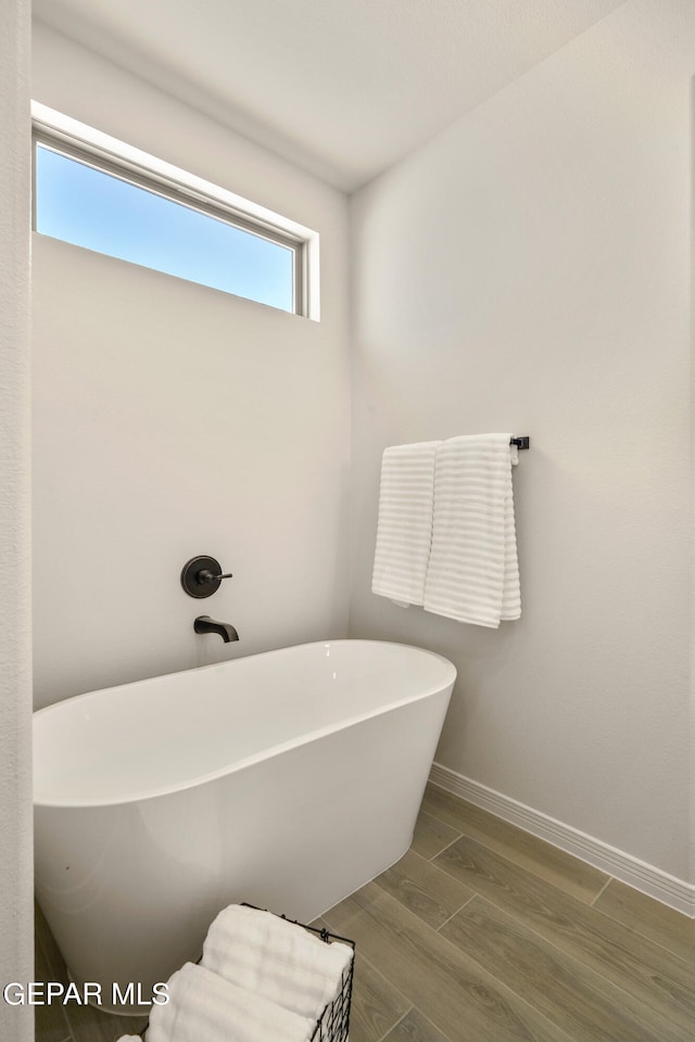 bathroom featuring hardwood / wood-style flooring and a bathing tub