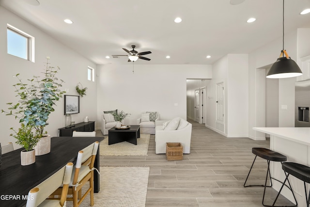 living room featuring ceiling fan and light hardwood / wood-style floors