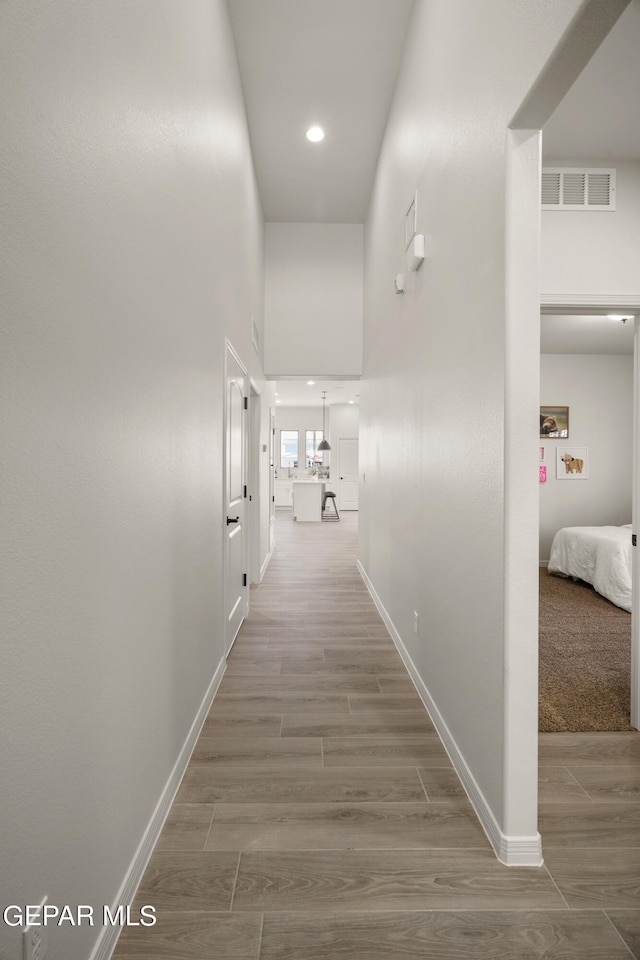 corridor with hardwood / wood-style floors