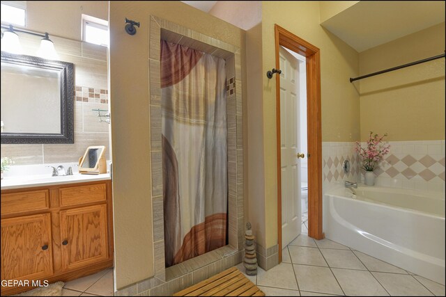 bathroom featuring vanity, tile walls, tasteful backsplash, and tile patterned floors