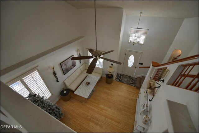 living room featuring high vaulted ceiling, ceiling fan, and wood-type flooring