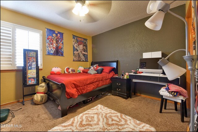 carpeted bedroom featuring a textured ceiling and ceiling fan