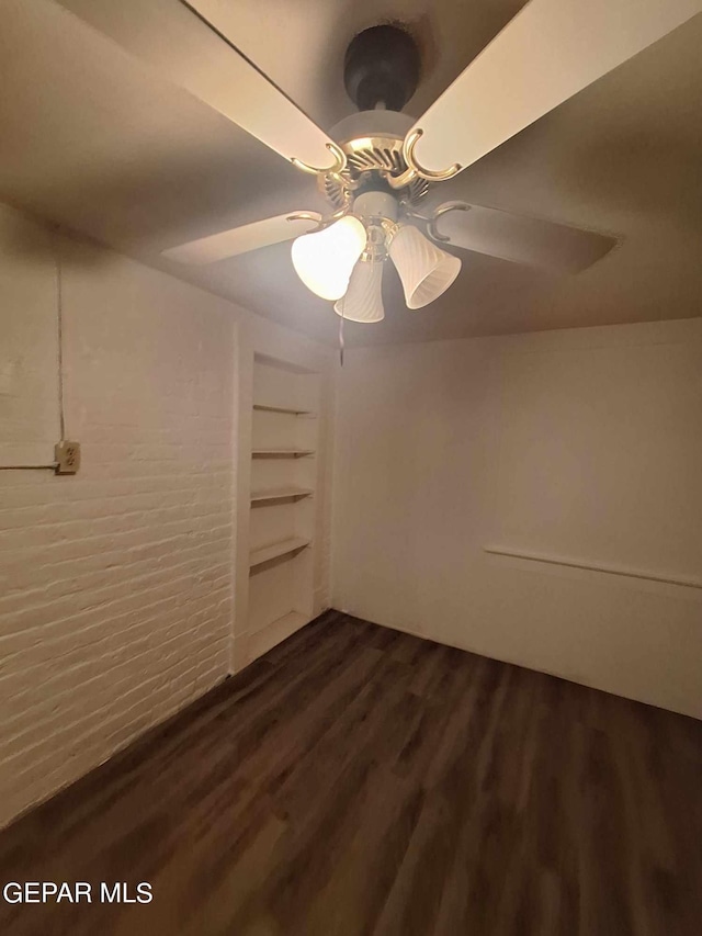 unfurnished room with built in features, ceiling fan, and hardwood / wood-style floors