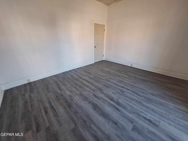 spare room with dark wood-type flooring