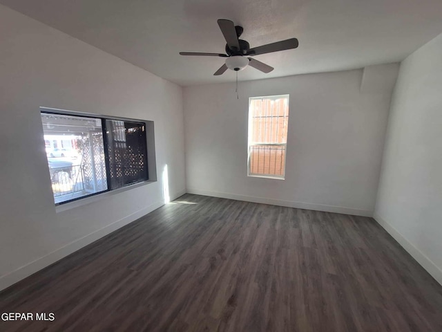 empty room featuring ceiling fan and dark hardwood / wood-style floors