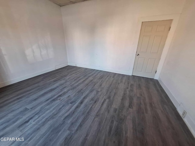 empty room with dark hardwood / wood-style floors