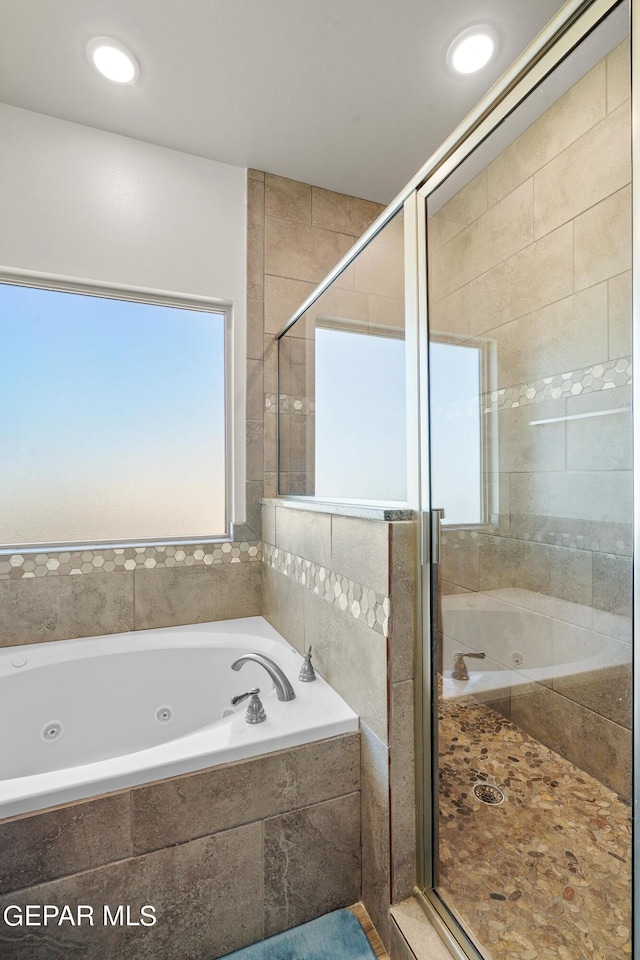 bathroom with shower with separate bathtub