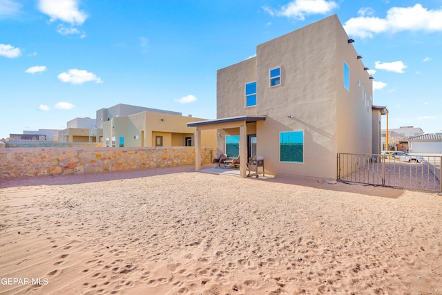 rear view of house featuring a patio