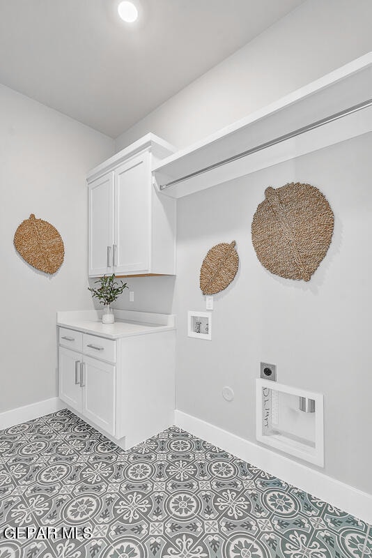 washroom featuring hookup for a washing machine, electric dryer hookup, cabinets, and light tile floors