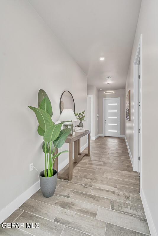 corridor with light hardwood / wood-style floors