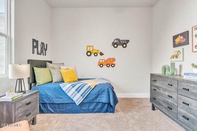 carpeted bedroom featuring multiple windows