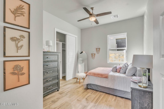 bedroom featuring a closet, light wood-type flooring, and ceiling fan