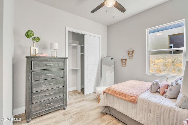 bedroom with a closet, ceiling fan, and light hardwood / wood-style flooring