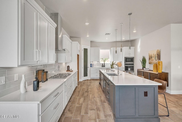 kitchen with a spacious island, white cabinets, and tasteful backsplash