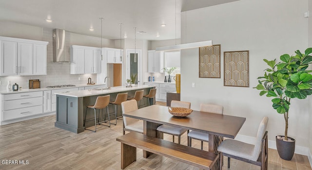 dining area featuring sink and light hardwood / wood-style floors