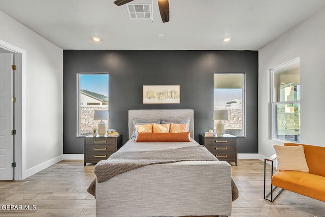 bedroom featuring light hardwood / wood-style floors and ceiling fan