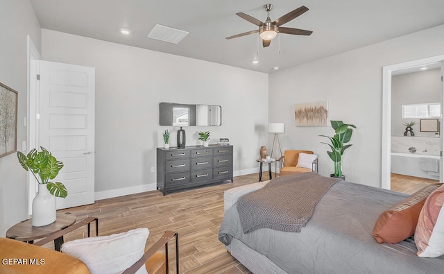 bedroom featuring light wood-type flooring, ensuite bathroom, and ceiling fan