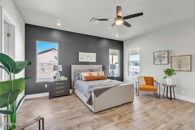 bedroom with light hardwood / wood-style floors and ceiling fan