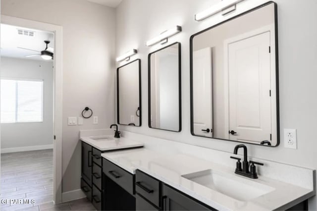 bathroom featuring ceiling fan, hardwood / wood-style floors, and vanity