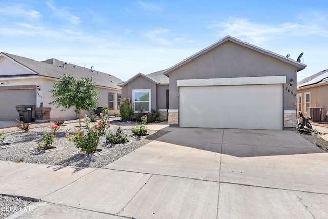 ranch-style home with central AC and a garage