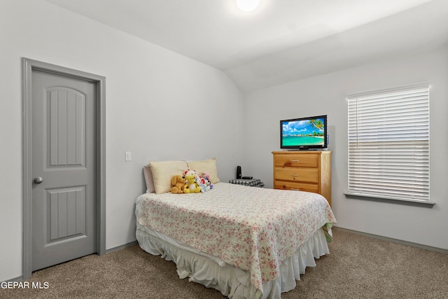 carpeted bedroom with lofted ceiling