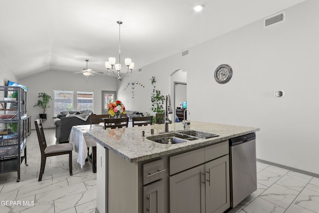 kitchen featuring sink, stainless steel dishwasher, lofted ceiling, decorative light fixtures, and a kitchen island with sink