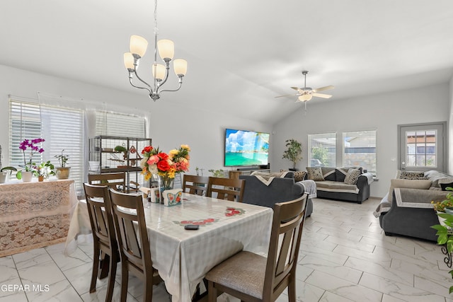 dining space with vaulted ceiling and ceiling fan with notable chandelier