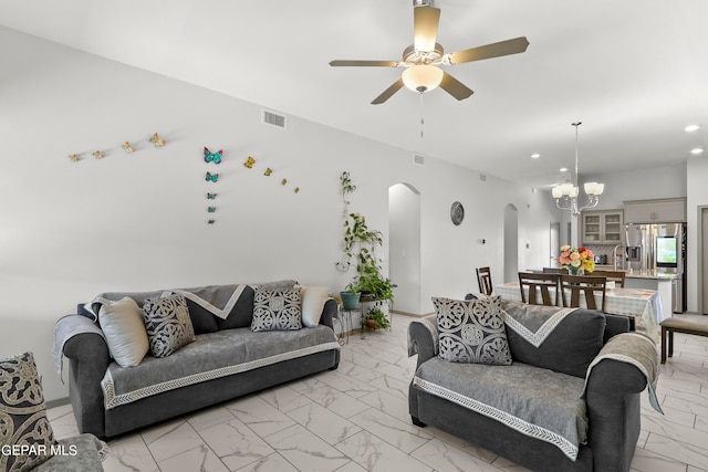 living room featuring ceiling fan with notable chandelier