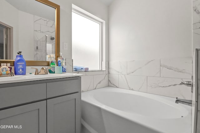 bathroom featuring a bathing tub, plenty of natural light, and vanity