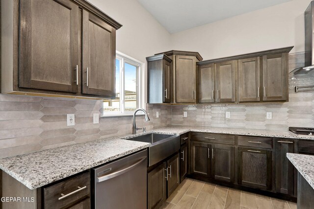 kitchen with wall chimney exhaust hood, tasteful backsplash, stainless steel dishwasher, light stone countertops, and dark brown cabinetry