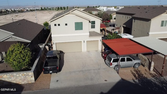 view of front of home with a garage and a carport